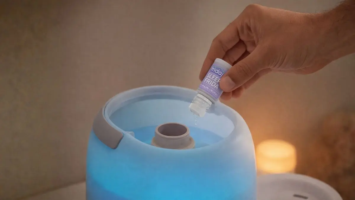 3 Proven Picks: Best Humidifier for Toddler Rooms (2026) 2 Adding vapor drops to the Frida Baby 3-in-1, an excellent humidifier for toddler congestion, with a Govee thermometer nearby