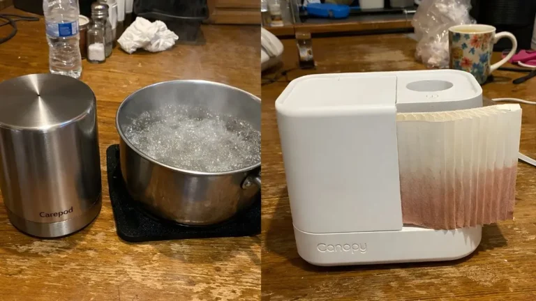 Side-by-side comparison of Carepod stainless steel humidifier tank next to boiling water and a white Canopy humidifier with a discolored pink paper filter on a kitchen table.