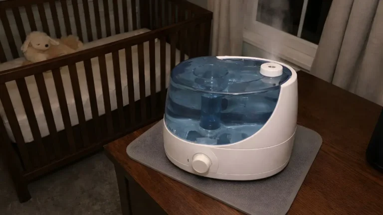 Safe humidifier placement in a baby room on a raised dresser with a waterproof mat at least three feet from the crib.
